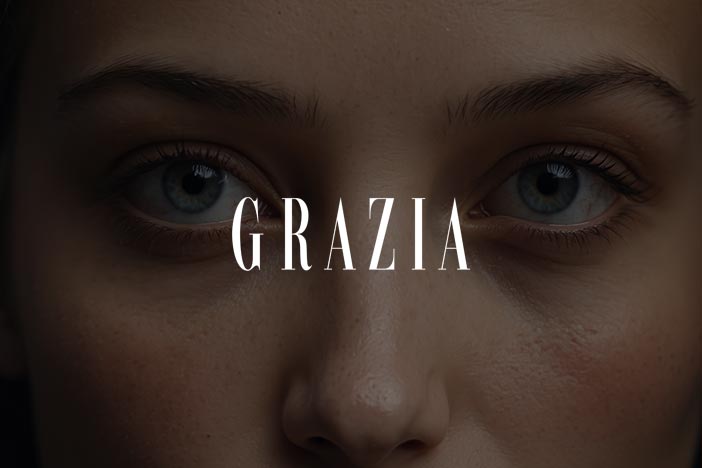 Close-up of a woman's face focusing on her eyes and under-eye area, highlighting natural skin texture, with Grazia text overlay.